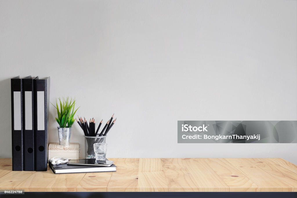 Work space Mock up white tabletop with files, pencils and houseplant. wood desk with copy space for products display montage. Desk Stock Photo