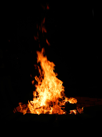 bonfire and embers on black background