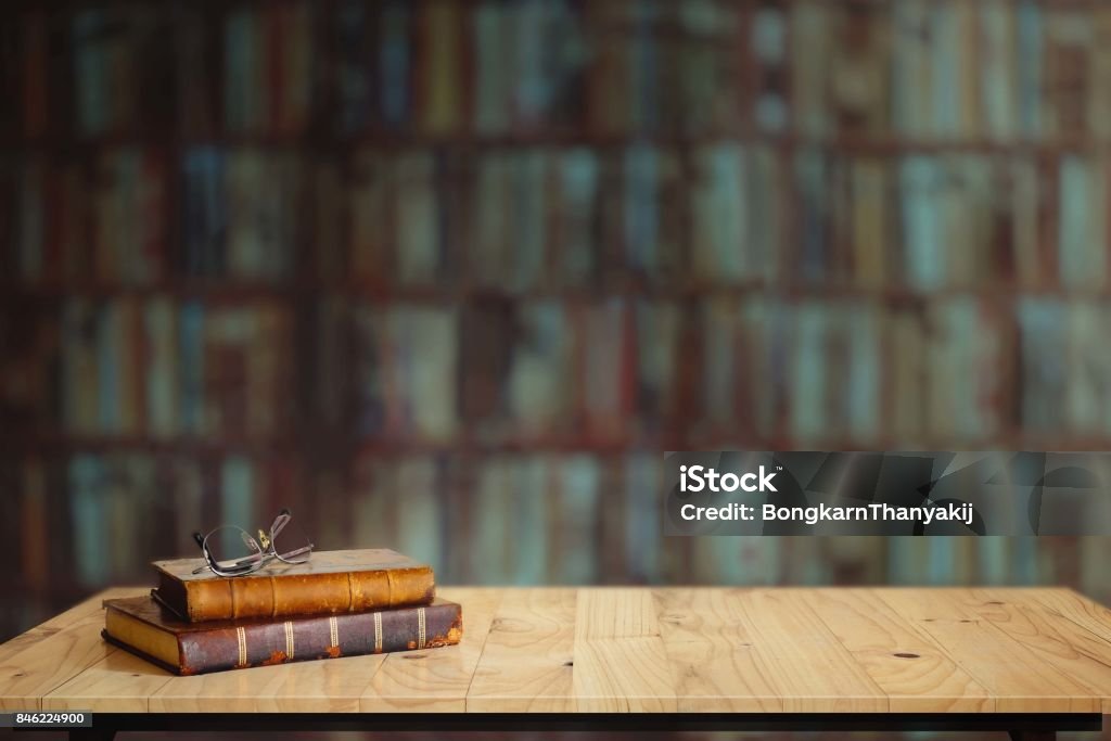 Vintage books on table in library. Book Stock Photo