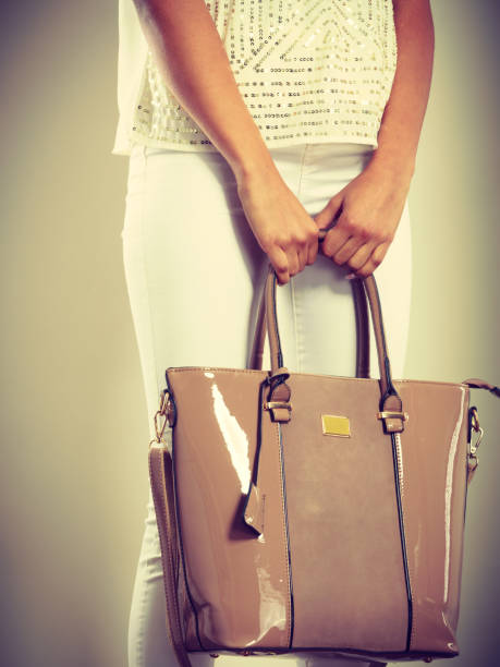 istock Woman holding beige lacquered leather bag. 846224914