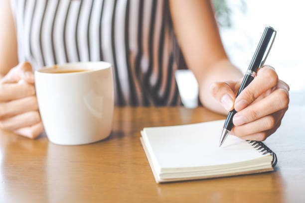 istock Business woman hand is writing on notebook
with a pen. 846225262