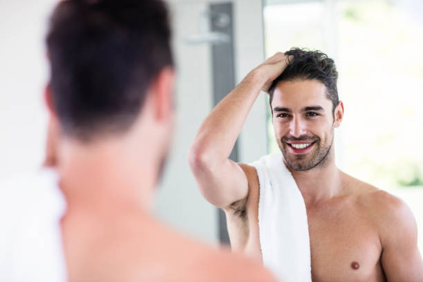 istock Handsome shirtless man looking in the mirror 846225928
