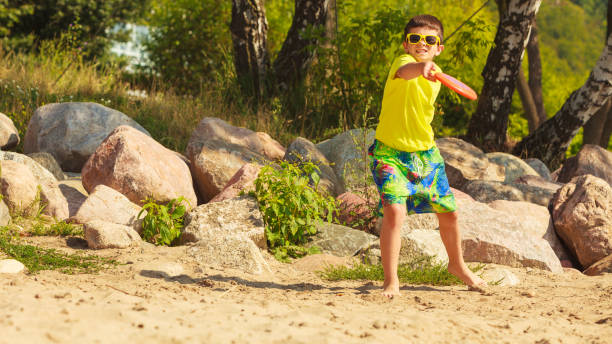 istock Little boy playing with frisbee disc. 846226042