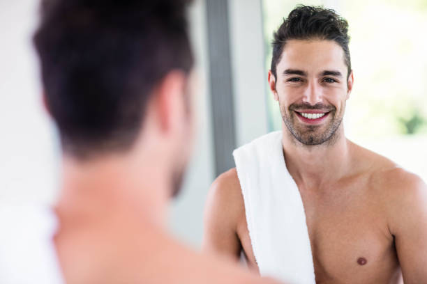 istock Handsome shirtless man looking in the mirror 846226056