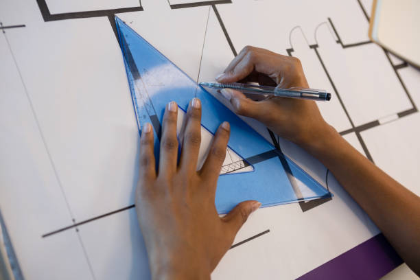 istock Hands of female architect working on blue print 846243450