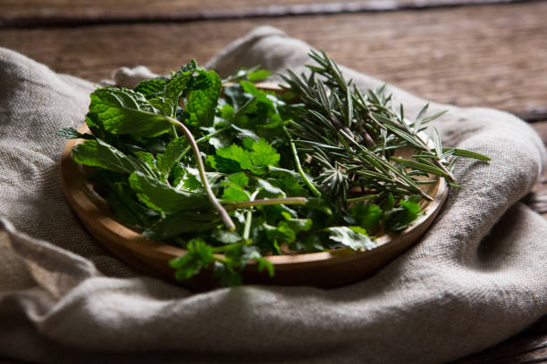 istock Fresh herbs in wooden plate 846243530