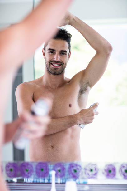 istock Handsome shirtless man putting deodorant 846251784