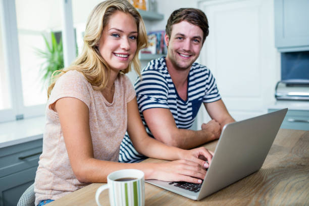 istock Smiling couple typing on laptop 846251868