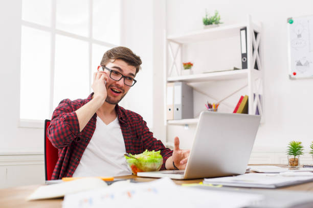 istock Busy man has business lunch in modern office interior 846253630
