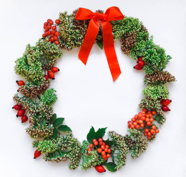 istock Green floral round wreath frame on white background. Flat lay, top view, view from above. Autumn or winter decoration 846254908