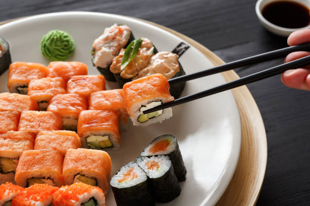 istock Eating sushi and rolls in japanese restaurant 846262670
