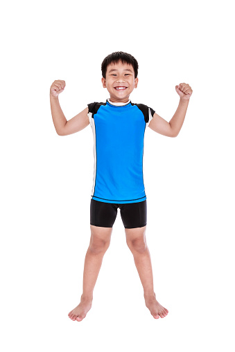 Full body of children powerful. Asian strong and confident boy cyclist is flexing biceps muscle fitness exercise and smiling happily. Healthy child lifestyle. Isolated on white background. Studio shot.