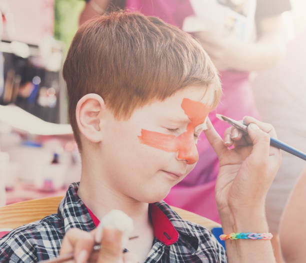 istock Child boy face painting, making tiger eyes process 846264000