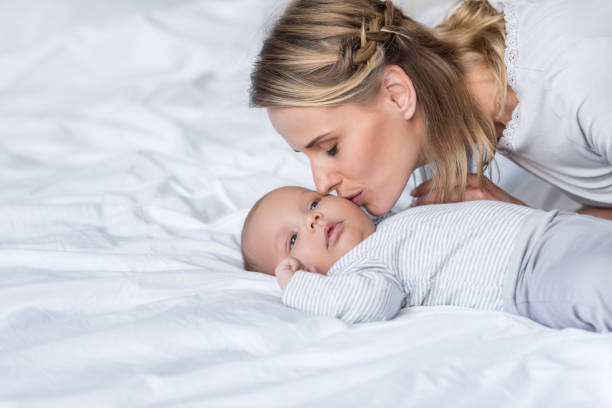 istock mother kissing her baby 846266542