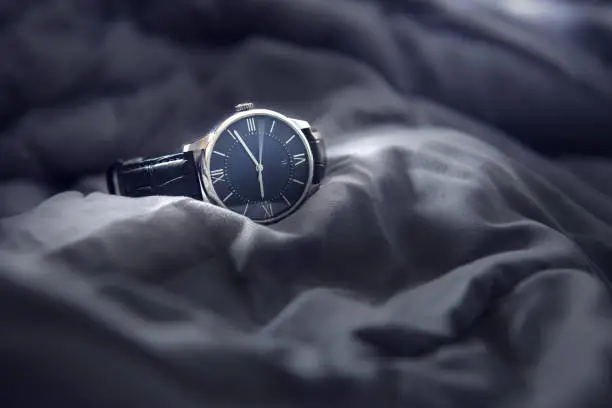 Photo of Closeup luxury man wrist watch black dial.