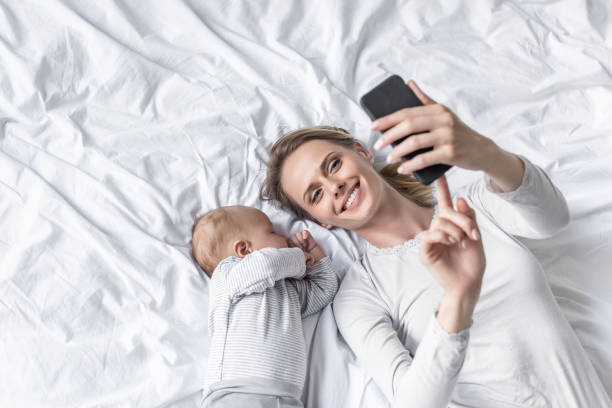 mother taking selfie with baby