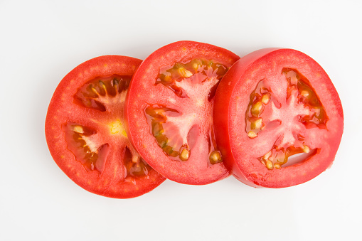 Fresh Tasty Slices Of Tomato On White Background