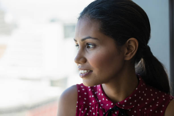 istock Close-up of thoughtful executive looking through window 846274900