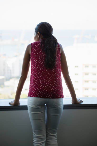 istock Rear view of executive looking through window 846274942