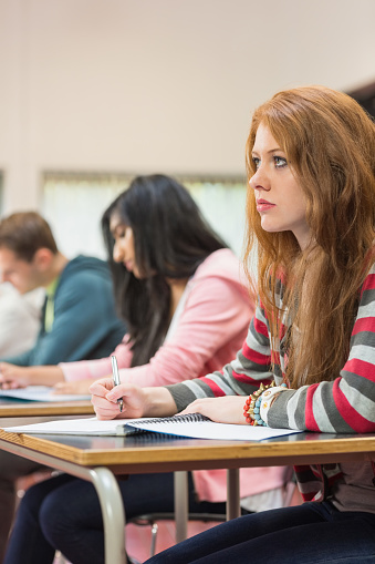 Young Students Writing Notes In Classroom Stock Photo - Download Image ...