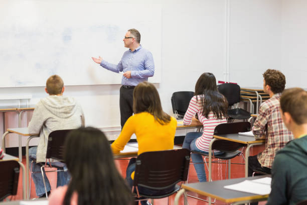 istock Attentive students with teacher in the classroom 846275886
