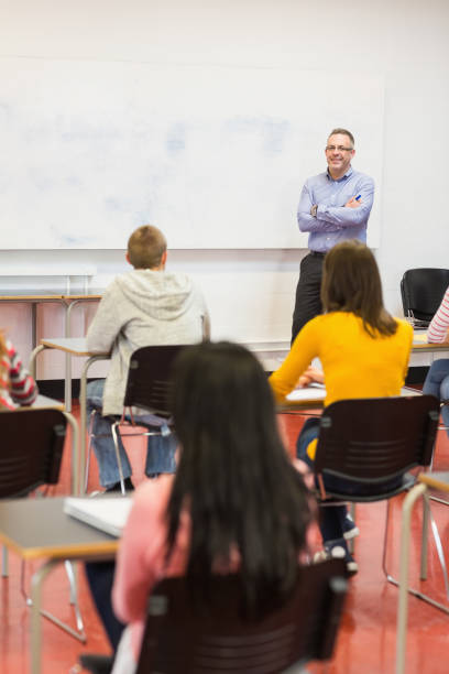istock Attentive students with teacher in the classroom 846275962