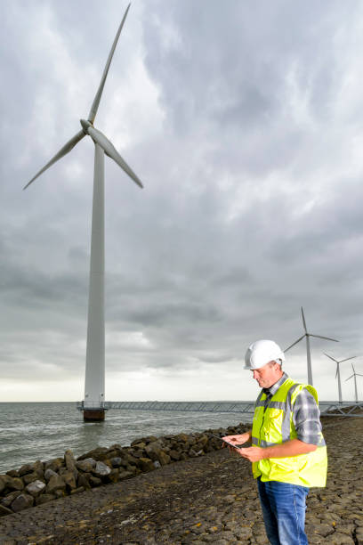 istock Engineer at an offshore wind turbine park during an overcast day 846278208