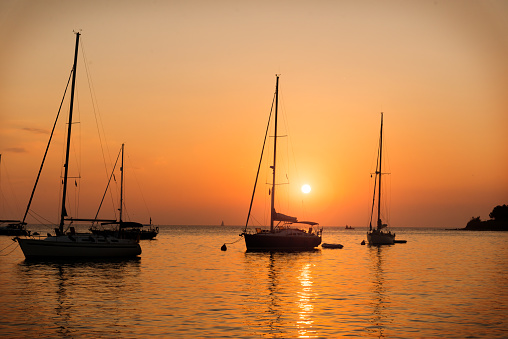 Silhouette of a sailboats during the sunset