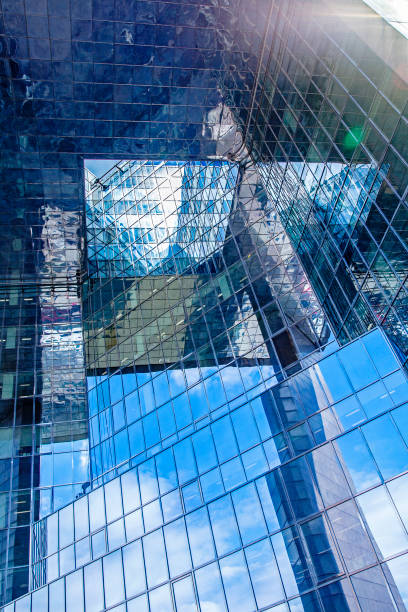 istock contemporary glass skyscraper reflecting the blue sky 846287728