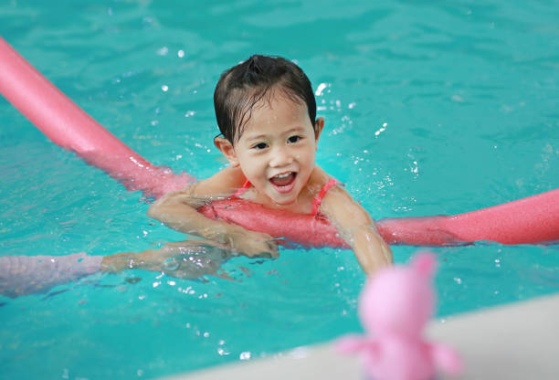 istock Little girl in swimming pool training. 846287840