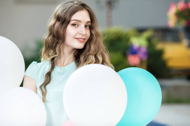 istock beautiful woman with flying multicolored balloons 846288654