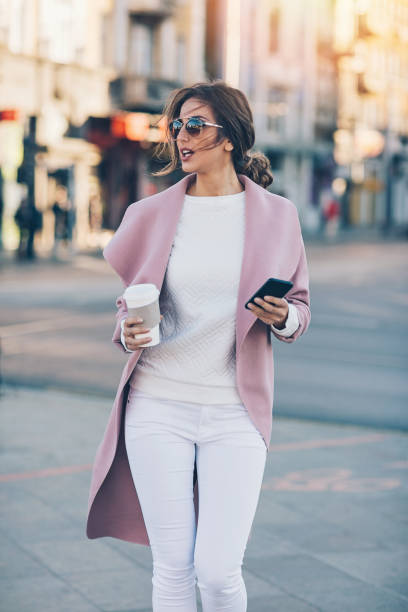 istock Young woman with smart phone and coffee 846288784