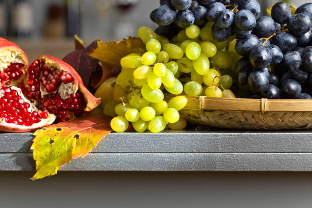 istock blue and green grapes with pomegranate  on kitchen table . 846297894
