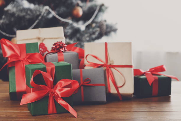 istock Christmas gifts on decorated tree background, holiday concept 846299652