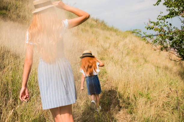 istock mother and daughter walking on grass 846299994