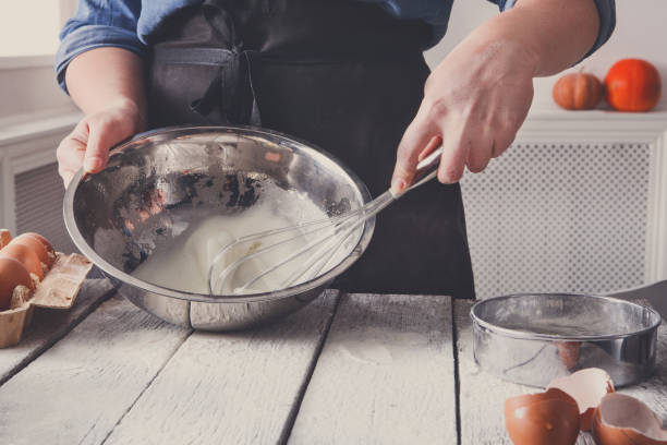 istock Woman baker stir dough with eggs and flour 846303846