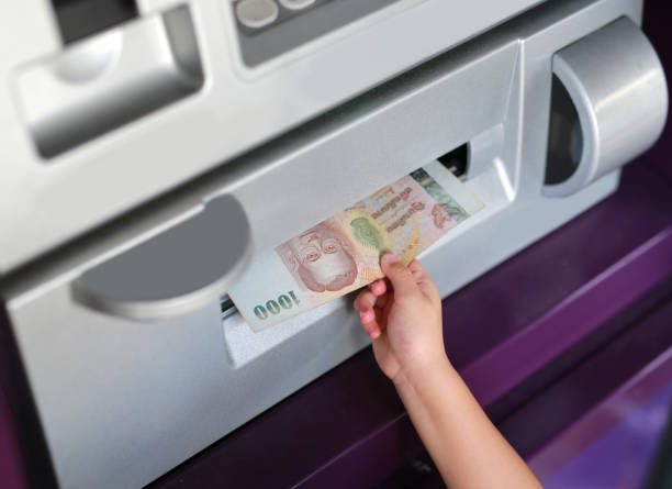istock Child hand receive money from ATM. 846304378