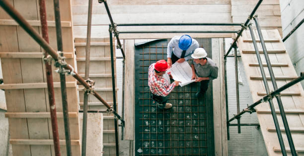 istock Foreman giving progress update to investor and architect as they stand at scaffold staircase 846307094