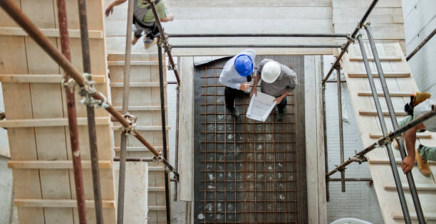 istock Male architect and male project manager discussing progress at construction site standing underneath scaffold staircase 846307178