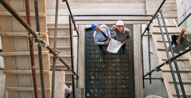 istock Male architect and male project manager discussing progress at construction site standing underneath scaffold staircase 846307210