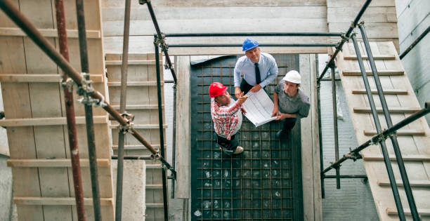 istock Foreman giving progress update to investor and architect as they stand at scaffold staircase 846307232