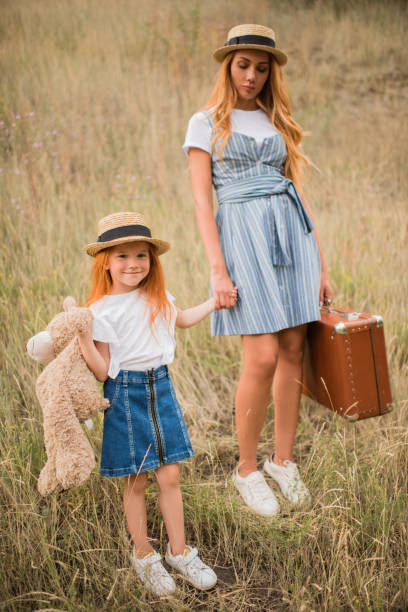 istock mother and daughter with suitcase and teddy bear 846310930