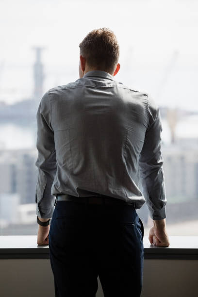 istock Rear view of executive looking through window 846318802