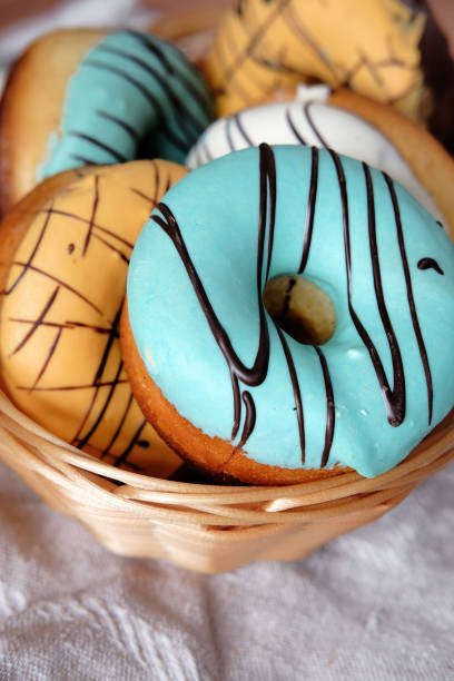 istock Fresh sweet doughnuts with multi colored icing and chocolate frosting. Fast food. 846319444