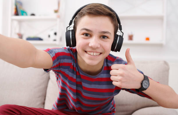 istock Boy in headphones taking selfie, like gesture 846319744