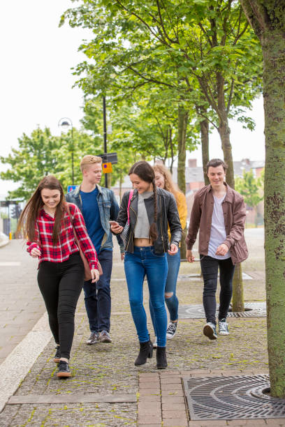 istock Young Adults Walk Down The Street 846319752