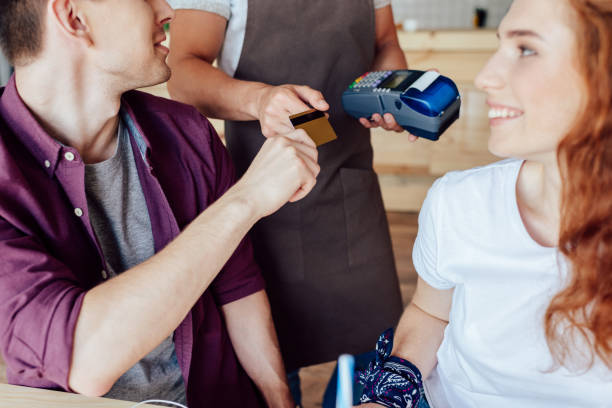 istock couple paying by credit card in cafe 846322760