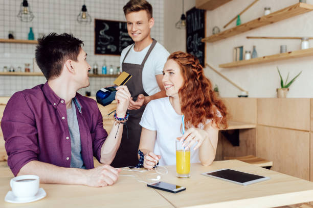 istock couple paying by credit card in cafe 846323050