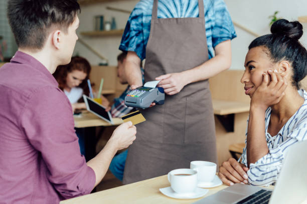 istock couple paying by credit card in cafe 846323392