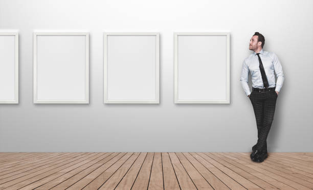Young business person looking blank picture frames